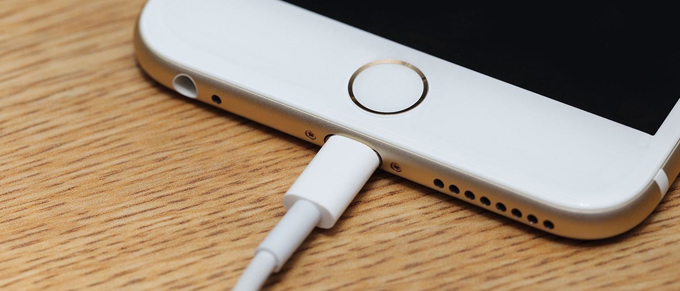 Phone charging cord pulled into a smartphone